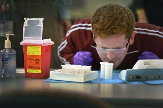 Philip Mason of the Health Department, analyzes a blood lead level at a recent screening.