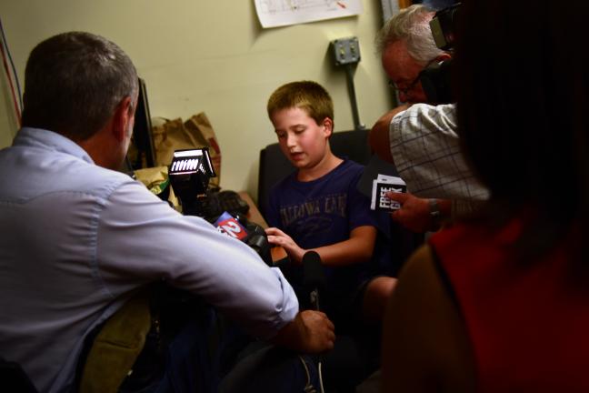 Eli Oman is interviewed by the press after receiving a free PC through the Free Geek, Multnomah County partnership