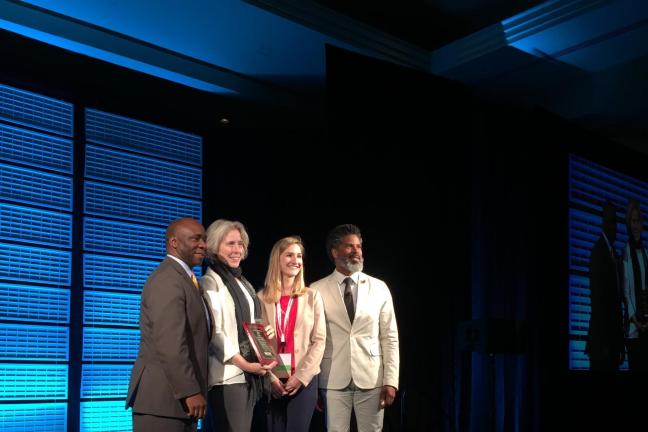  Amy Sullivan, second left, and Kelly Howard, second right, accept the award. 