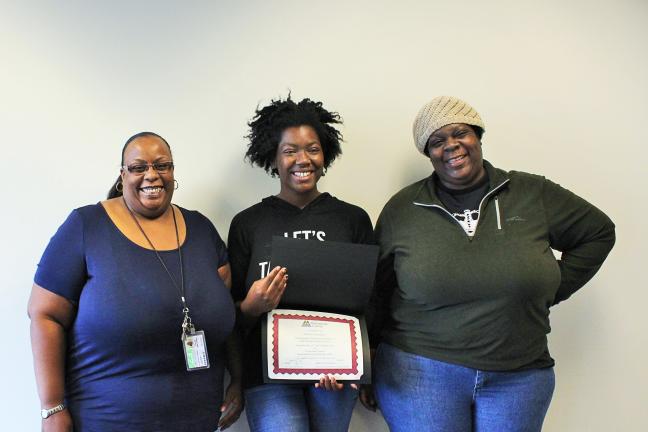 Kalisha, center, poses with family after being honored for saving a life.