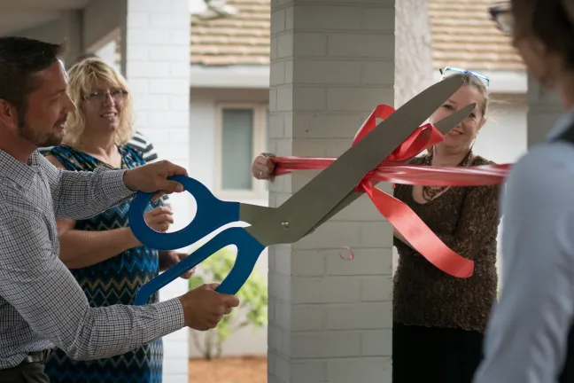Monta Knudson cuts the ribbon at the new Intensive Outpatient Treatment center supportive housing