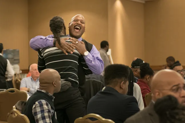 Guests at Black Men and Boys Healing Summit hug