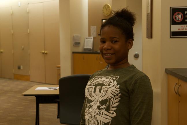 Bravo Youth Orchestras student Sapphire Thomas smiles for camera after delivering board presentation.