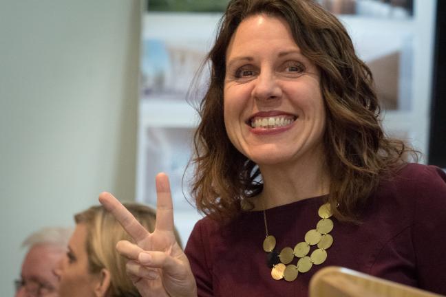 Chair Deborah Kafoury holds up peace sign at event.