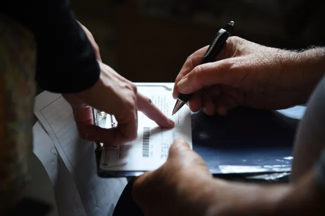 For people who are unable to sign their ballot, Watanabe and Van Meter carry an inkpad which allows a person to thumbprint an attestation form, which is then linked to the voter’s registration.