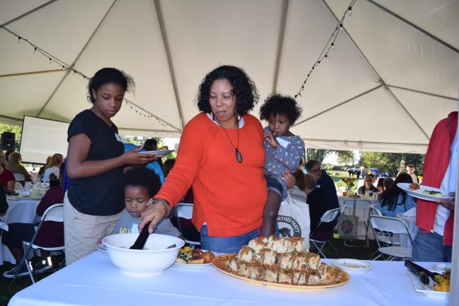 A family selects food from the buffet