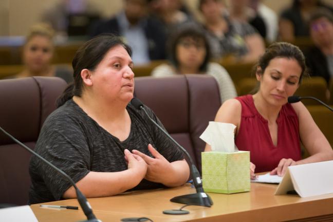 A supporter of Lifeworks NW's Strengthening Families program speaks to the Multnomah County Board of Commissioners on Wednesday, May 3, 2017. Patricia Rojas of El Programa Hispano Catolico, right, looks on.
