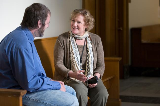 Diversion Courts Program Manager Jean Dentinger (right) chats with a Mental Health Court participant.