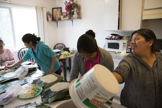 Neighbors gather to make Tamales at Adelfa's apartment in the Normandy complex.