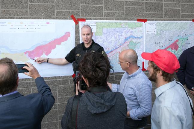 People look at a revised map of evacuation zones near the Eagle Creek Fire.