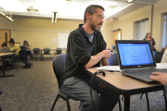 David Smith applied for healthcare during a March 2014 insurance assistance fair.