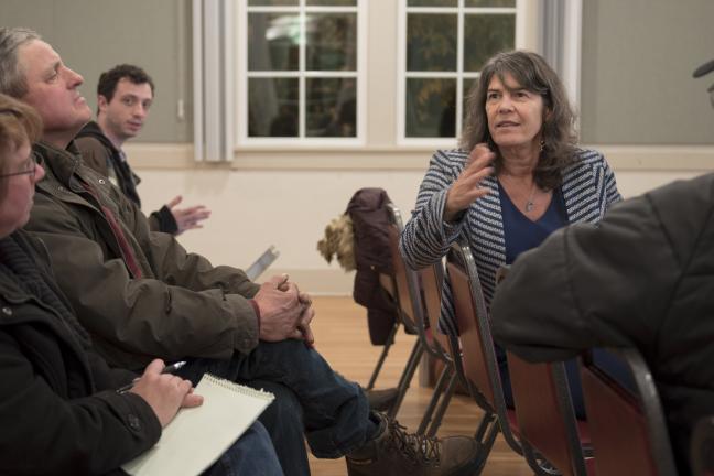 Commissioner Sharon Meieran talks to Corbett residents during a community meeting on a proposed wood smoke ordinance.