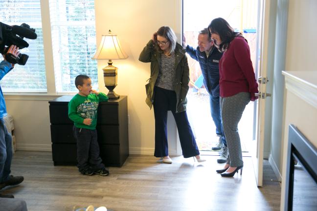 Michael Bunch talks with a reporter and team members from ekoLiving, which is offering the apartment he and his mother moved into.