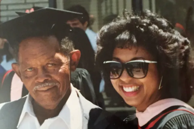 Vanetta Abdellatif poses with her grandfather Prentice Walker as she graduates with a master's degree in public health and health services administration.