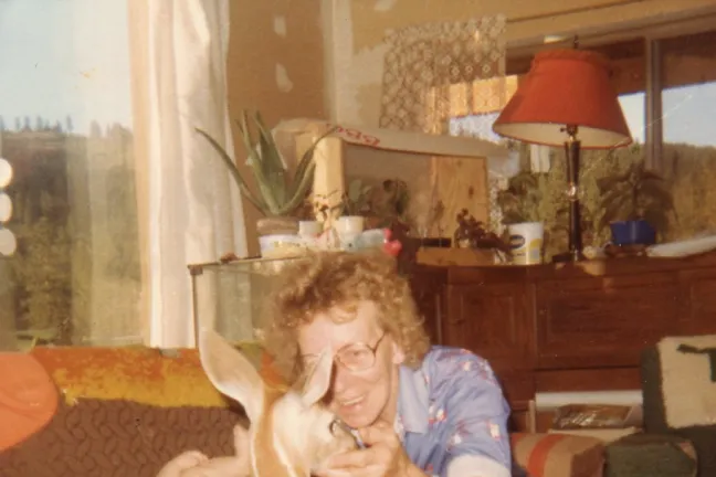 Wendy's mother tending to two babies: her nephew and the family deer.