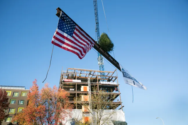 The last steel beam is lifted onto the Gladys McCoy Health Department Headquarters.