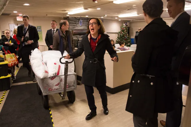 Gov. Kate Brown carts in donations at the Human Solutions Family Center.