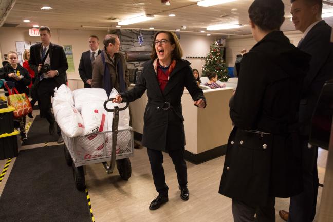 Gov. Kate Brown carts in donations at the Human Solutions Family Center.