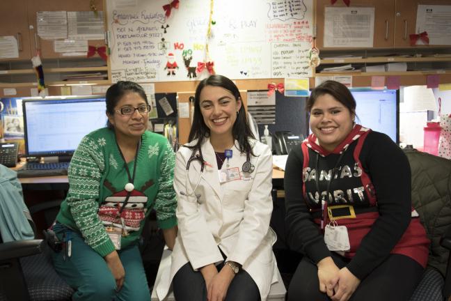 Physician assistant Daniela Schlechter-Keenan pauses for some holiday cheer with medical assistants Marisa Morales, left, and Cynthia Arevalo.