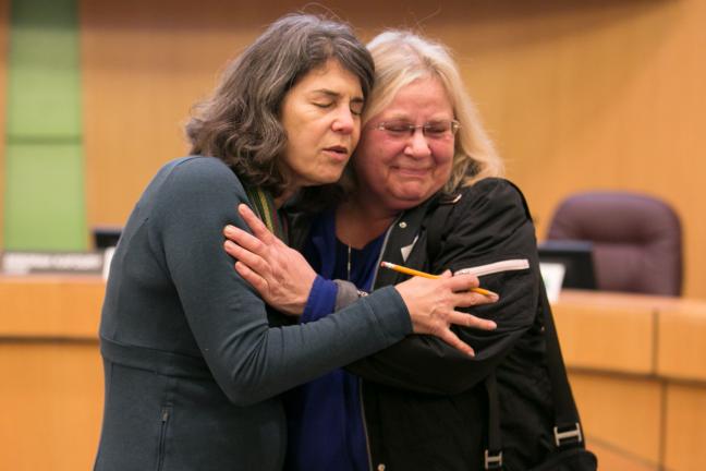 Commissioner Sharon Meieran comforts mother Charlene Turenne after an emotional listening session on mental health services