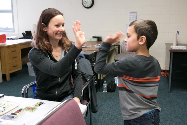 Greyson Carrillo-Bobo, 6, gives nurse Sara McCall a high five after a series of immunizations.