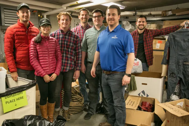 Volunteers with the construction firm JE Dunn sort clothing donations at Bud Clark Commons.