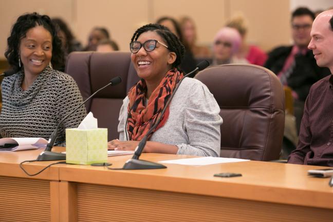 Nikoyia Phillips, a health educator with REACH, talks to commissioners