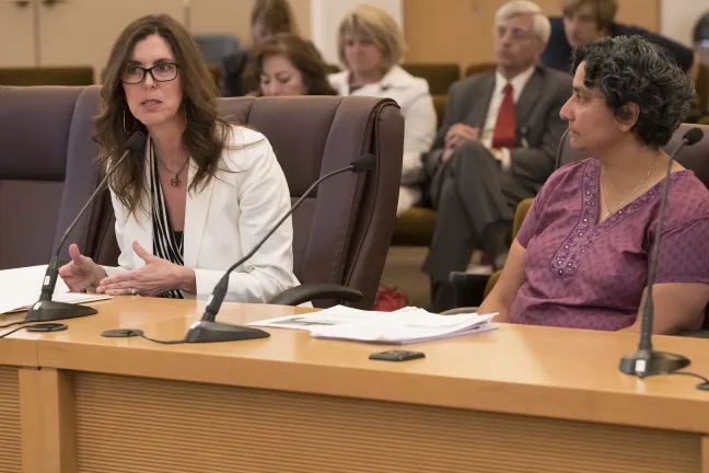 Chris Farentinos, (left) the Vice President for Unity briefs commissioners alongside Nimisha Gokaldas, Medical Director for Multnomah County's Mental Health and Addition Services Division