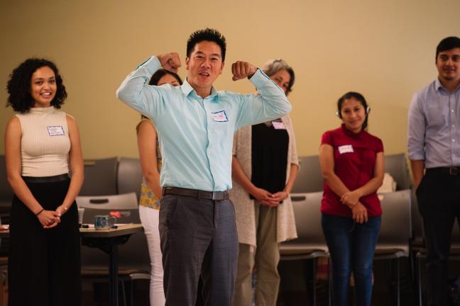 OPAL Environmental Justice Oregon Executive Director Huy Ong signalling during a team-building exercise that he wants to build power by the people.