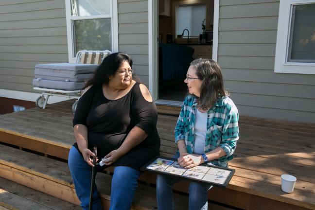 Sherry and Martha chat on the porch of Sherry's new home.