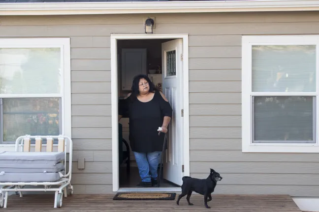 Sherry pauses in doorway of her new home.