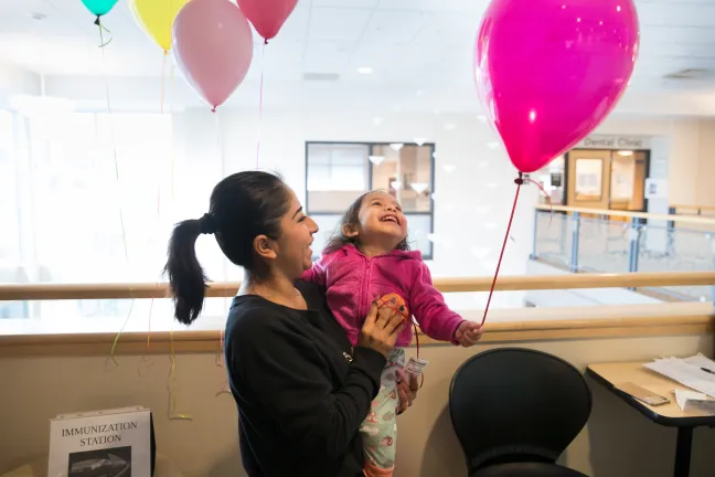 Aliyael Diaz-Moreno giggles iwth her mom Liliana Moreno after getting her flu shot at the Baby Day Dental clinic in Gresham.