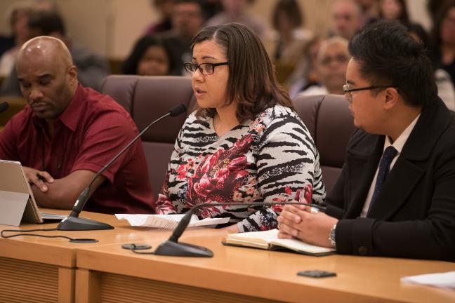 Aimeera Flint, Health Department employee and member of the Employees of Color Employee Resource Group, speaks to commissioners at Tuesday’s briefing. She was joined by Local 88’s Percy Winters Jr. and Employees of Color ERG co-chair Raymond de Silva.