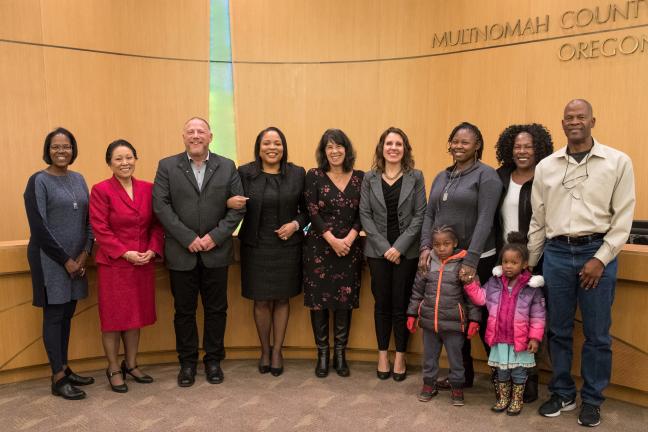 Members of the Gladys McCoy Family join Board of Commissioners in adopting new hiring standard