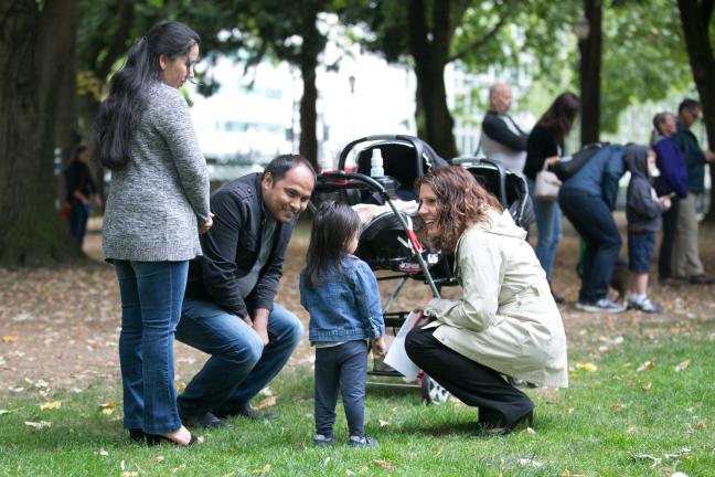 Chair Deborah Kafoury talks to the Subedi family during a welcoming rally in Portland