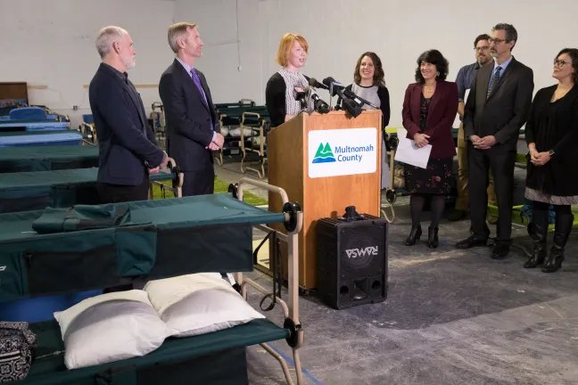 Brandi Tuck of Portland Homeless Family Solutions speaks before the opening of the community's winter family shelter in December 2018.