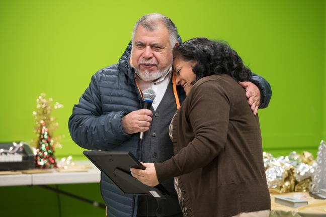 Parents hug each other at the launch of the Parent Handbook event.