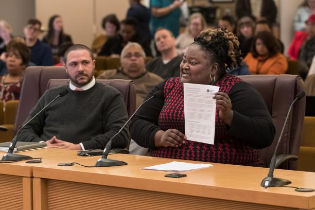 Chair Kafoury’s Chief of Staff Kim Melton displays the draft Implementation plan as Chief Diversity and Equity Officer Ben Duncan looks on.  