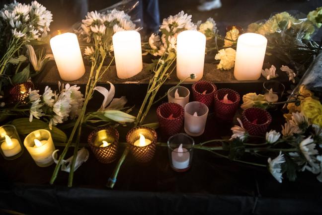 Candles and flowers to honor those who died experiencing homelessness