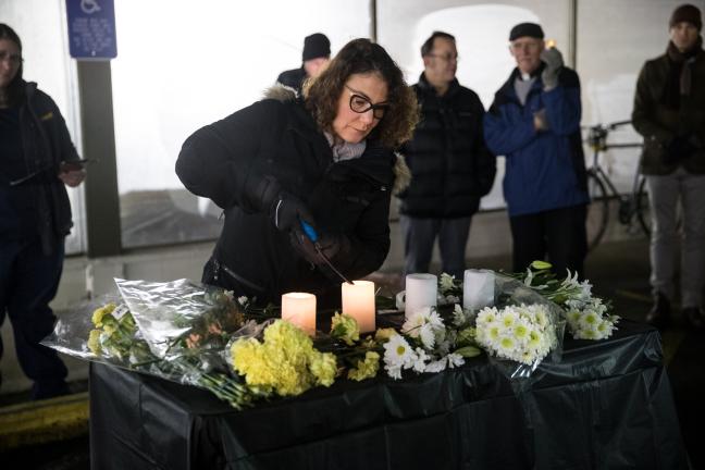 Commissioner Jessica Vega Pederson lights a candle.