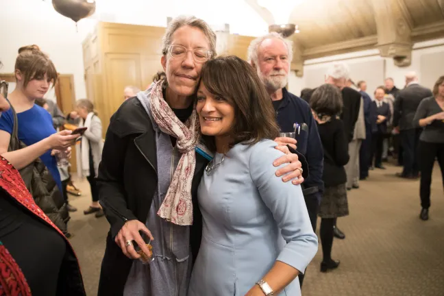 Susheela Jayapal stops to hug Helen Daltoso for the Regional Arts and Culture Council
