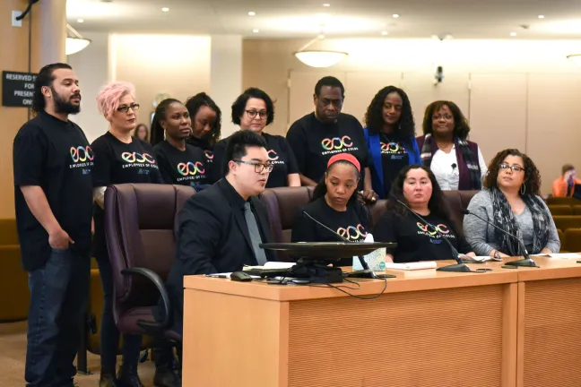 Employees of Color (EOC) Employee Resource Group Co-Chair Raymond de Silva addresses the Board surrounded by his fellow EOC members.