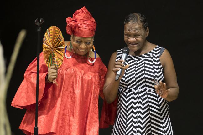 Antoinette Edwards who MC'd the event, stands next to a Diane Wade House resident.