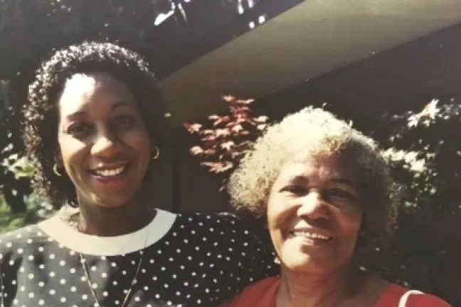 Patricia Charles-Heathers, pregnant with her son Jason, at her doctoral graduation, with her mother Hadassah Chapman.