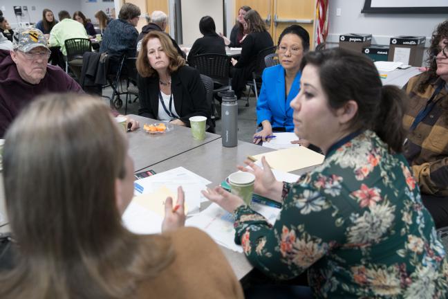 Members of the community discuss outreach with a representative from the U.S. Census Bureau and Commissioner Lori Stegmann.