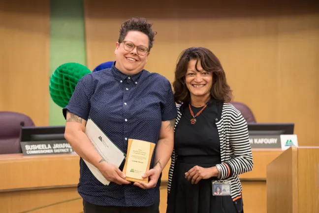 Commissioner Jayapal (right) with the library's Lyndsey Runyan, winner of the Diversity & Cultural Competency Award.