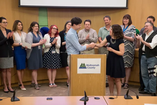 Chair Kafoury (right) shakes hands with Jacob Farkas, Multco Align project manager