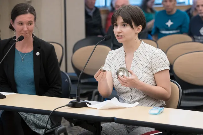 Syringe exchange volunteer Madelyn O’Kelley-Bangsberg holds up a "cooker" which can become contaminated and cause infection.