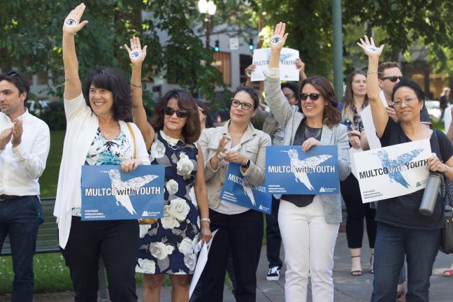 Board members cheer youth they formally support in climate case.