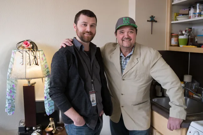 Brennan Edwards, Central City Concern case manager (right) poses for picture with his Ty Grove.
